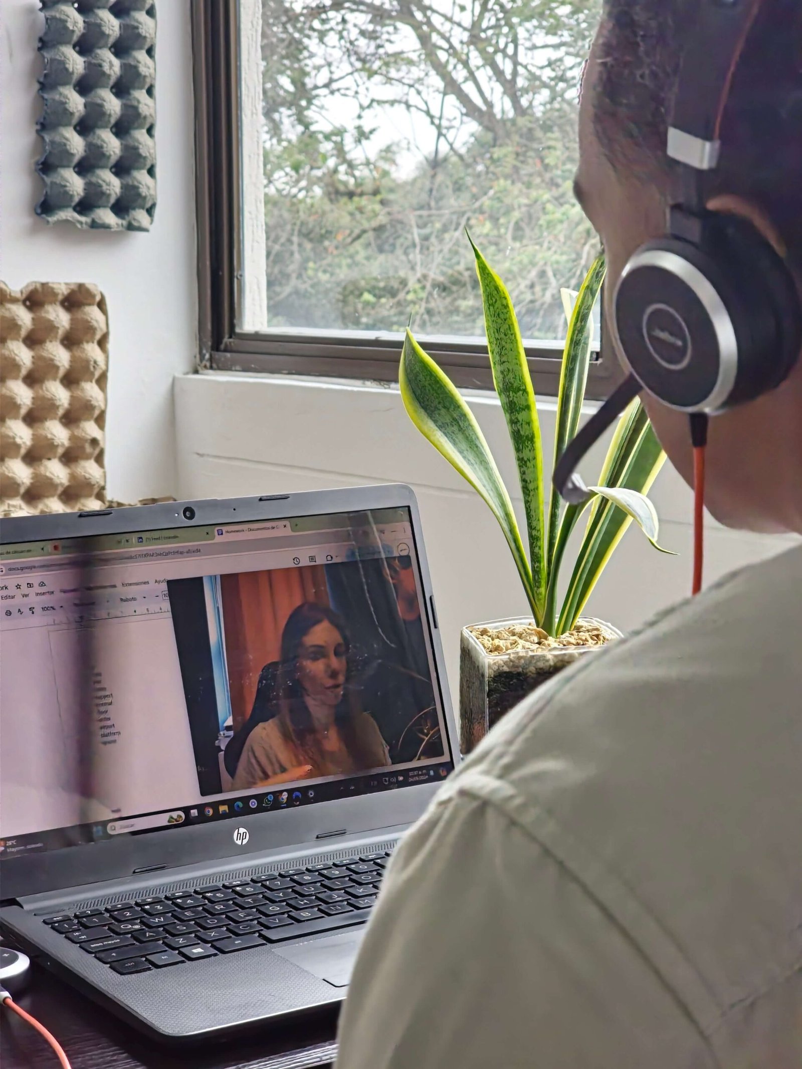 Over-shoulder view of a pronunciation drill video playing on a laptop, representing self-paced practice